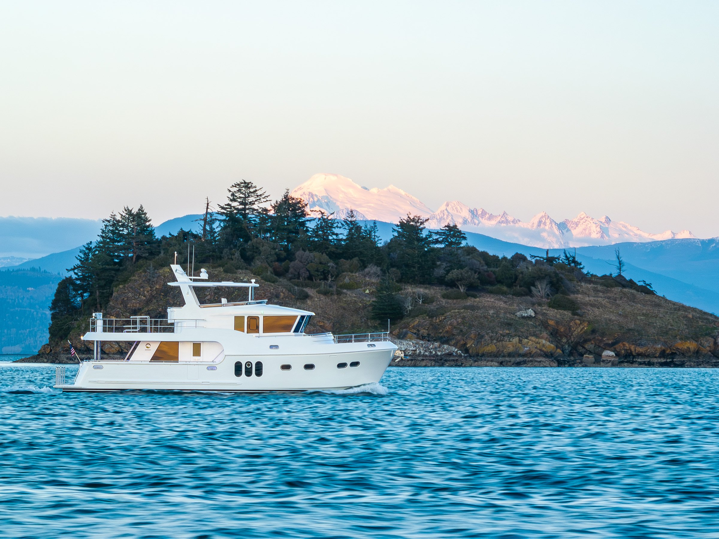Northwest 55 cruising in Salish Sea with Mount Baker in background during sunset.